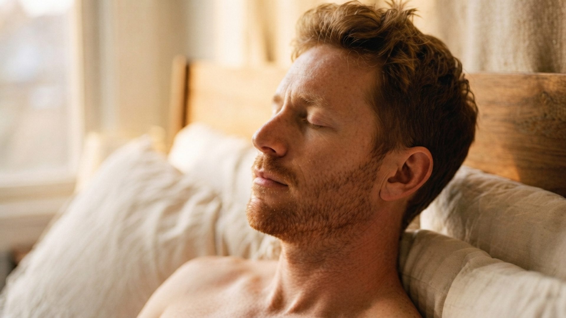 Person lying in bed with toes hanging outside the covers.