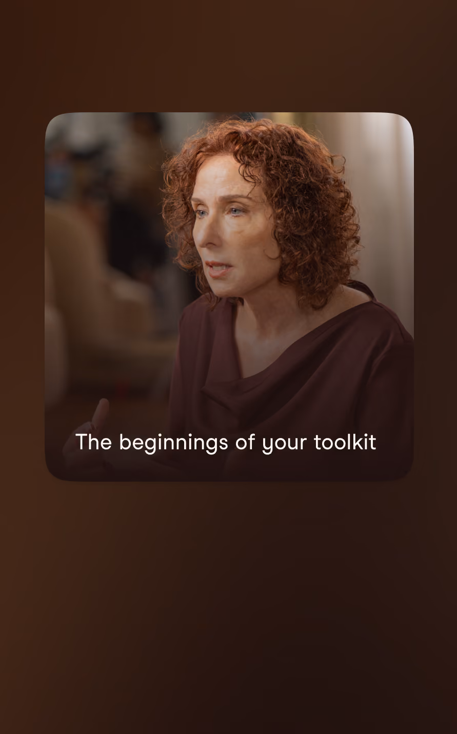 A woman with curly red hair and a serious expression speaks, captioned with 'The beginnings of your toolkit.'